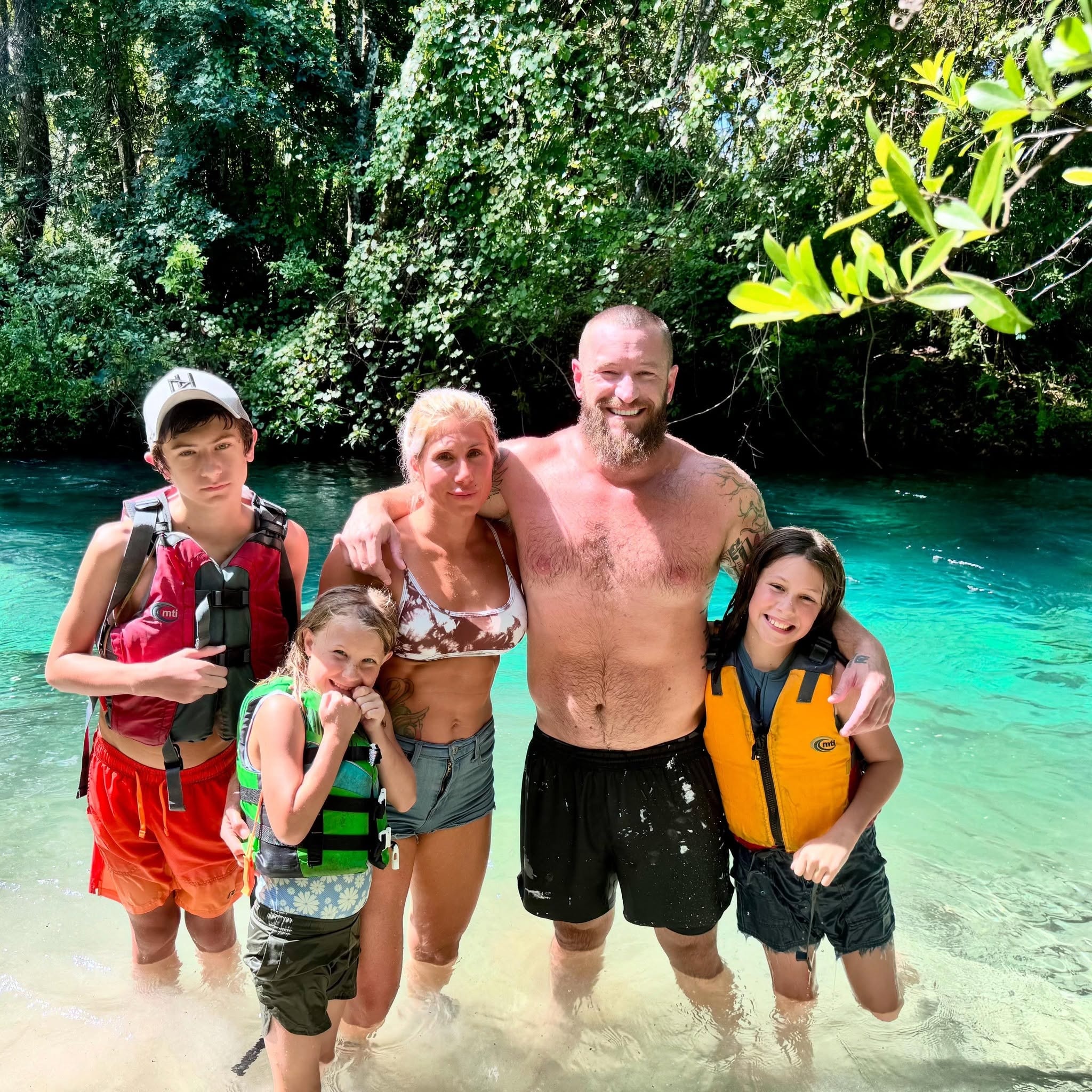 Trading coach with family in tropical water